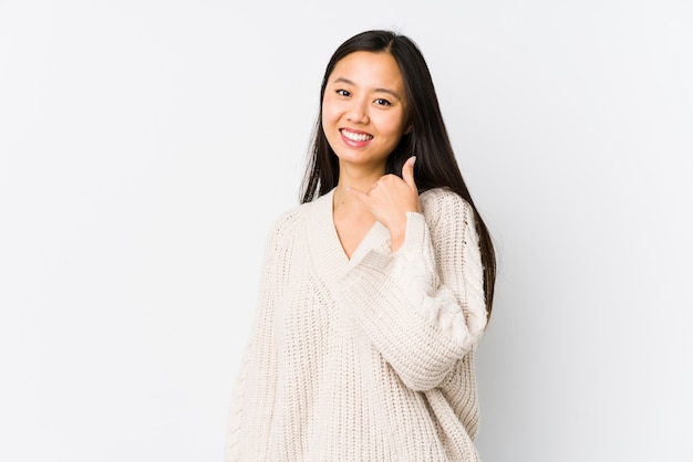 Young chinese woman isolated showing a mobile phone call gesture with fingers.