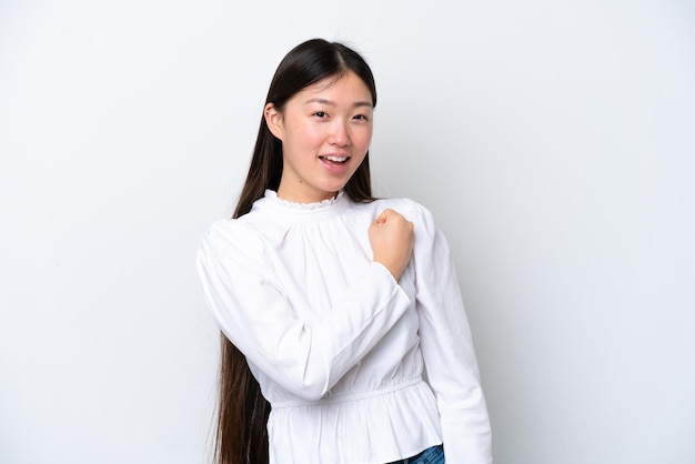 Young Chinese woman isolated on white background celebrating a victory