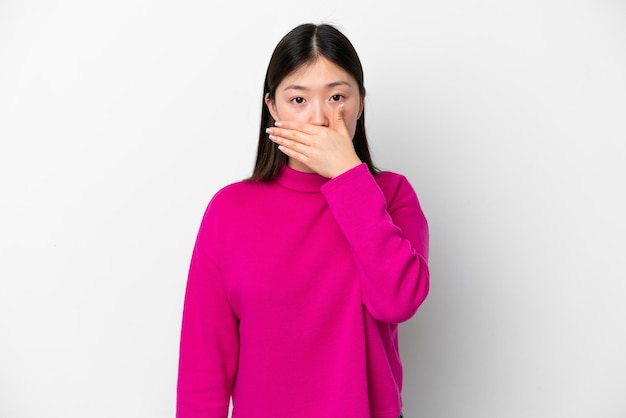 手で口を覆っている白い背景に分離された若い中国人女性