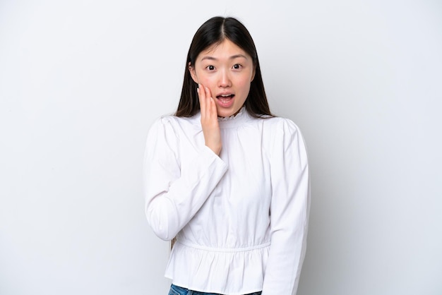 Young Chinese woman isolated on white background with surprise and shocked facial expression