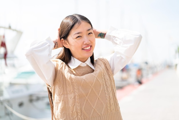 Young Chinese woman at outdoors With happy expression