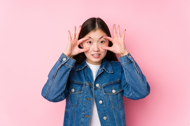 Young chinese woman posing in pink