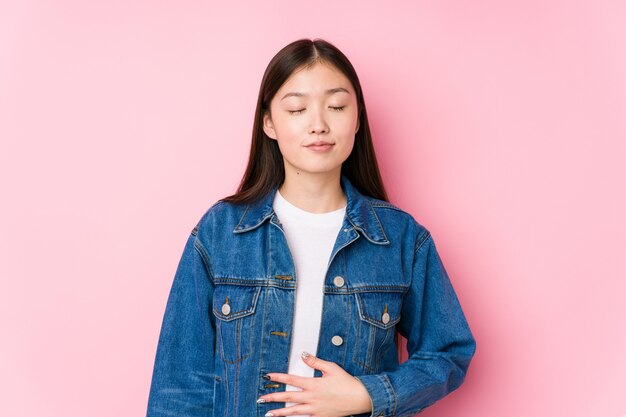 Young chinese woman posing in pink