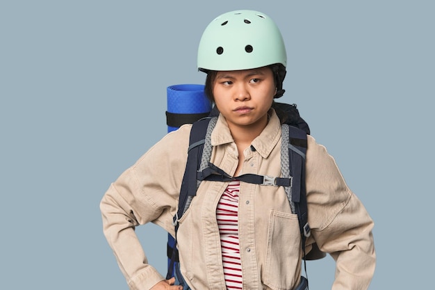 Young Chinese woman ready for hiking in studio