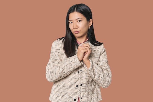 Young Chinese woman in studio setting scared and afraid