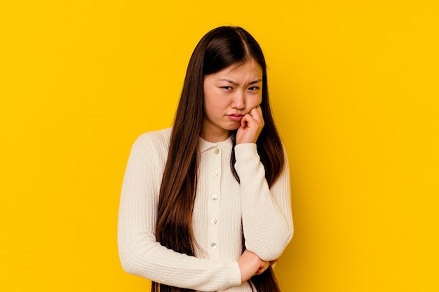 Young chinese woman  tired of a repetitive task.