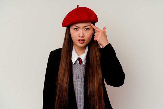 Young chinese woman wearing a school uniform isolated on white showing a disappointment gesture with forefinger.