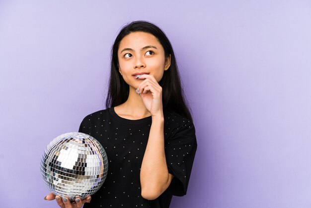 Young chinese woman with disco ball