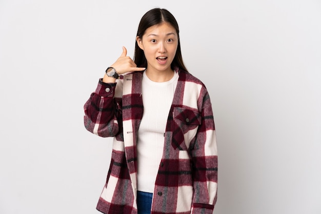 Young Chinese young woman isolated making phone gesture