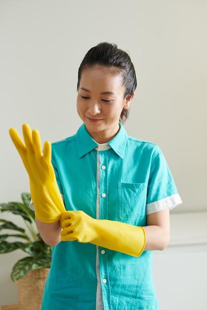 Young cleaner in uniform at work