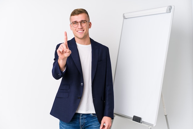 Young coaching man showing a white board showing number one with finger.