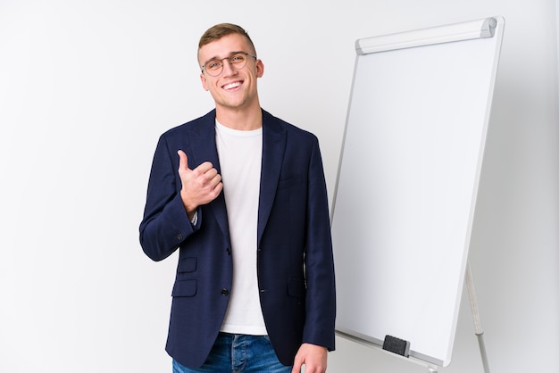 Young coaching man showing a white board smiling and raising thumb up