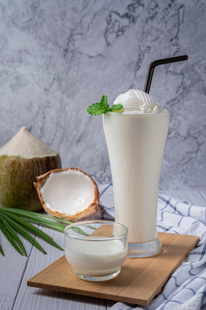 Young coconut juice smoothie in glass, Fresh sweet healthy coconut milk shake.