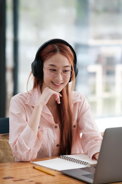 Young collage student using computer and mobile device studying online