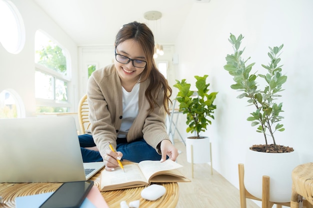 Young collage student using computer and mobile device studying onlinexA