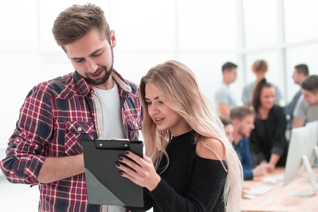 Young colleagues with business documents standing together