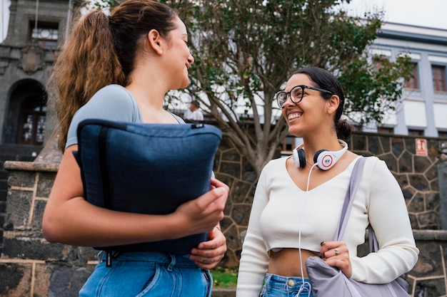 Young college friends laughing together on campus