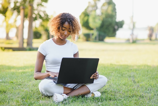 Young college student sitting on the lawn