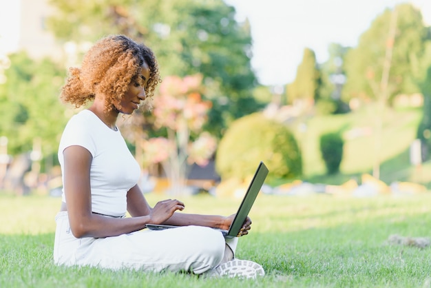 Young college student sitting on the lawn