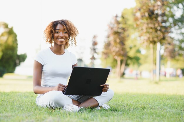 Young college student sitting on the lawn