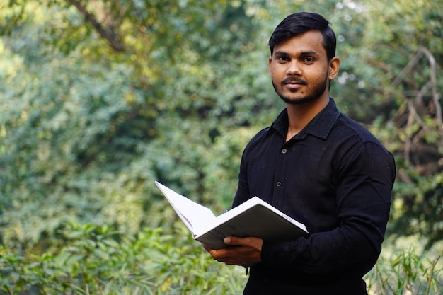 Young college student watching camera and giving a smile