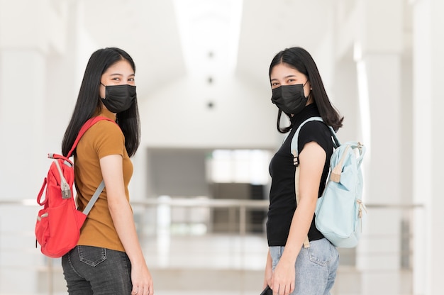 Young college student wearing a black cloth mask, Back to School,