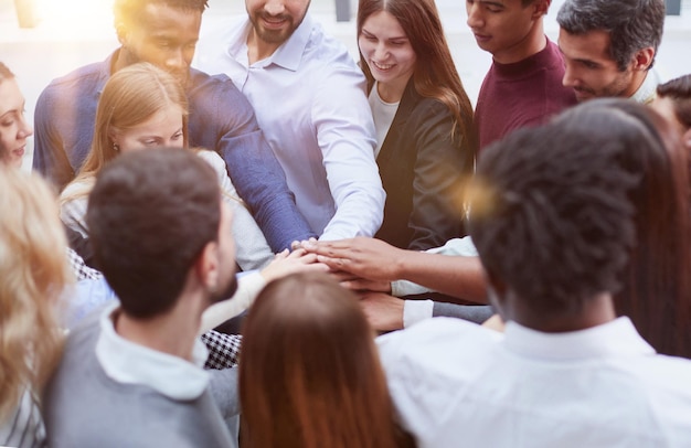 Young college students teamwork stacking hand concept