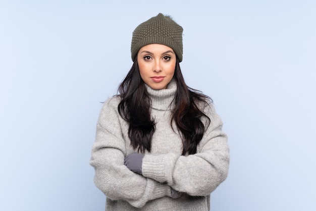 Young Colombian girl with winter hat keeping arms crossed