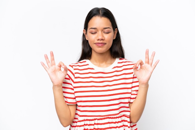 Young Colombian woman isolated on white background in zen pose