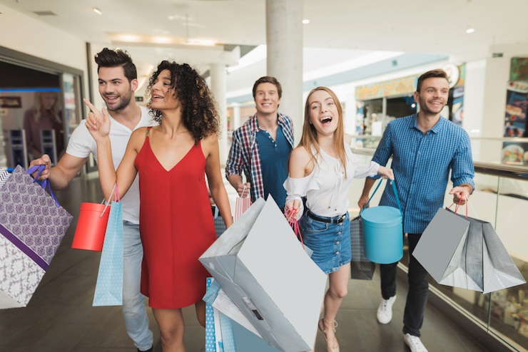 Photo young company shopping at the mall. black friday.