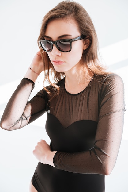 Young concentrated lady wearing sunglasses