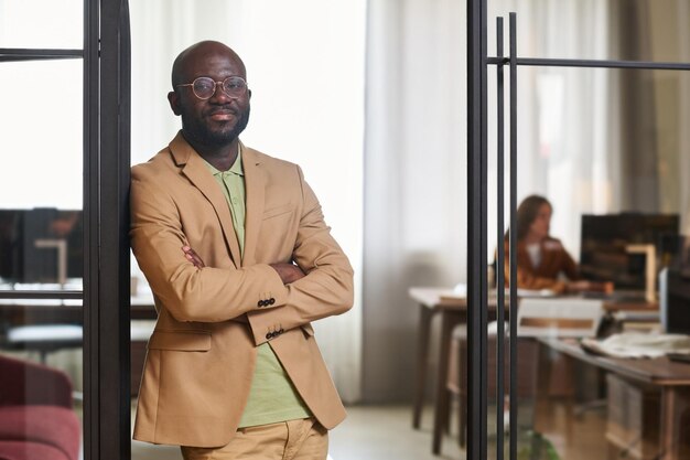 Young confident businessman in formalwear standing in door of coworking area