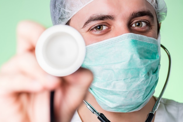 Young confident and friendly doctor holding stethoscope