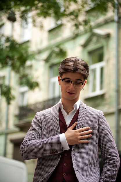 Young confident man in formal clothes outdoor in the cit