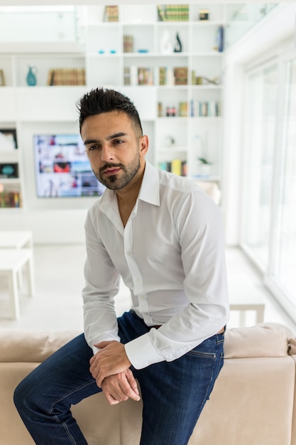 Young confident man at modern home