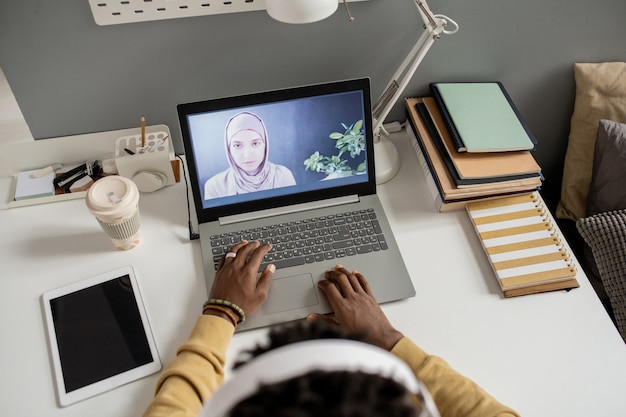 Young confident teacher on laptop screen looking at student