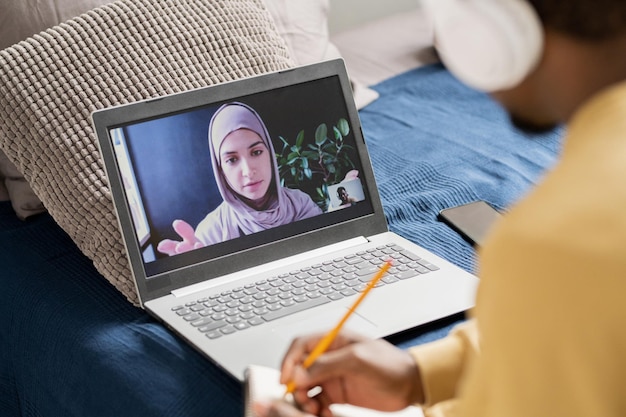 Young confident teacher on laptop screen looking at student