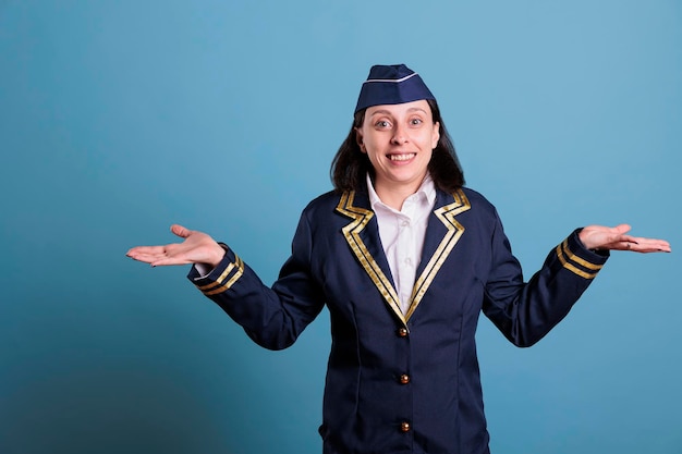 Young confused flight attendant shrugging shoulders, showing\
unsure gesture, looking upwards. air hostess with doubtful facial\
expression, puzzled stewardess, uncertain sign