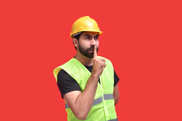 young construction worker asking to keep silent and not to make noise indian pakistani model