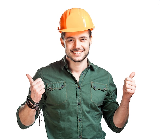 Young construction worker in hard hats on a white wall