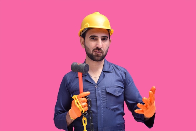 young construction worker holding chain and hammer pakistani model