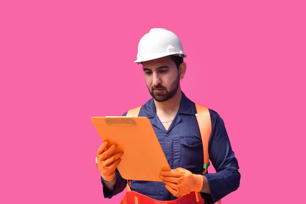 young construction worker holding clipboard and looking it indian pakistani model