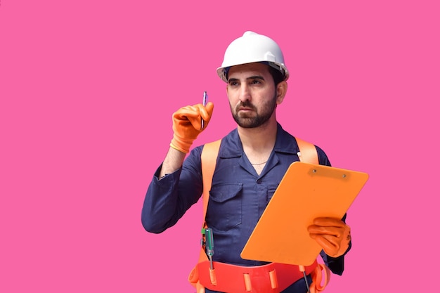 young construction worker holding clipboard and pen indian pakistani model