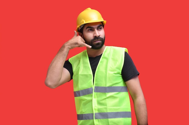 young construction worker making phone call gesture indian pakistani model