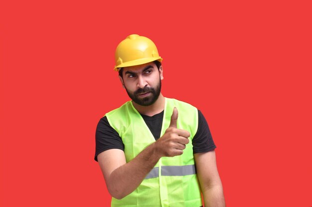 young construction worker showing like gesture indian pakistani model