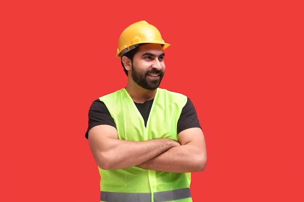 young construction worker smiling and wearing safety vest indian pakistani model