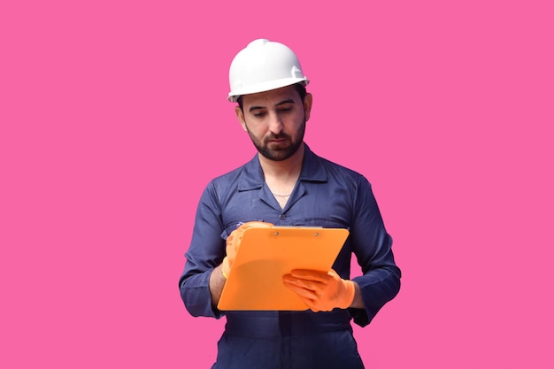 young construction worker writing on clipboard indian pakistani model