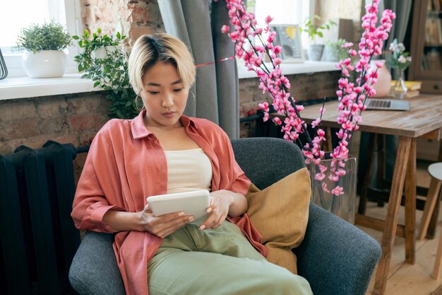 Young contemporary asian woman with tablet