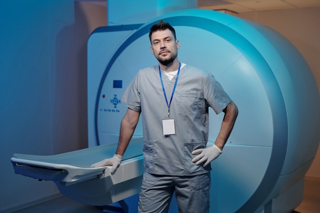 Young contemporary radiographer in grey uniform