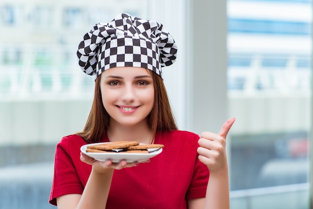 Young cook preparing cookies in the kitchen